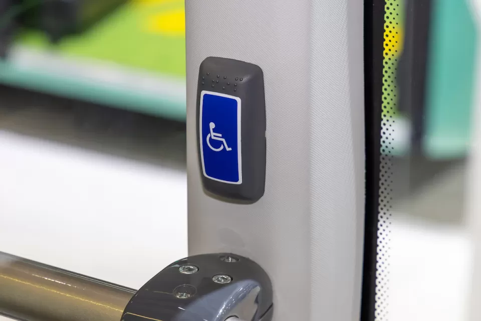 Close-up of accessible stop button on public bus.